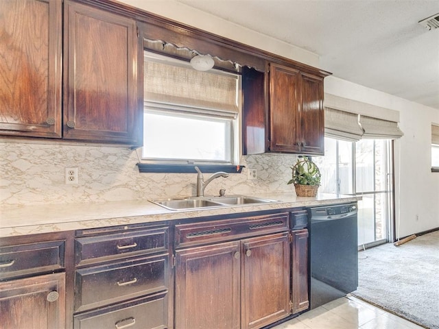 kitchen featuring a sink, black dishwasher, a wealth of natural light, and light countertops