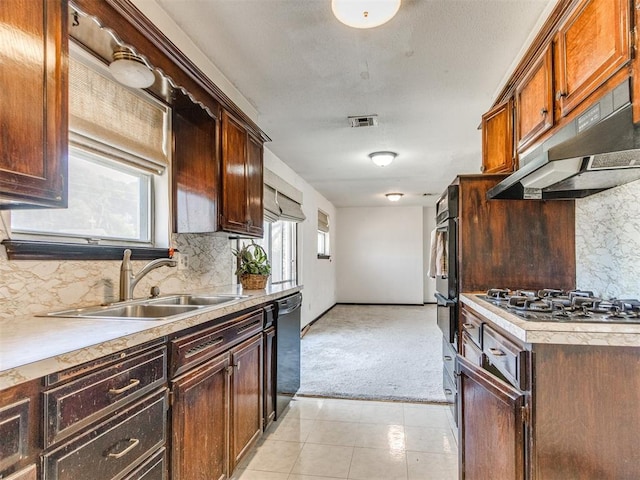 kitchen with visible vents, black appliances, a sink, under cabinet range hood, and light countertops