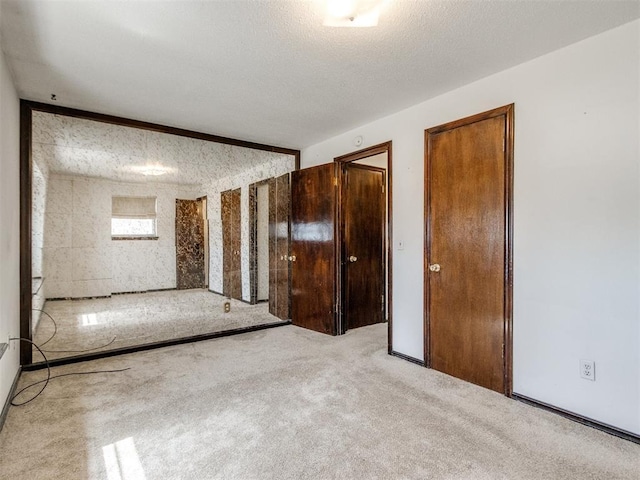 carpeted spare room featuring a textured ceiling