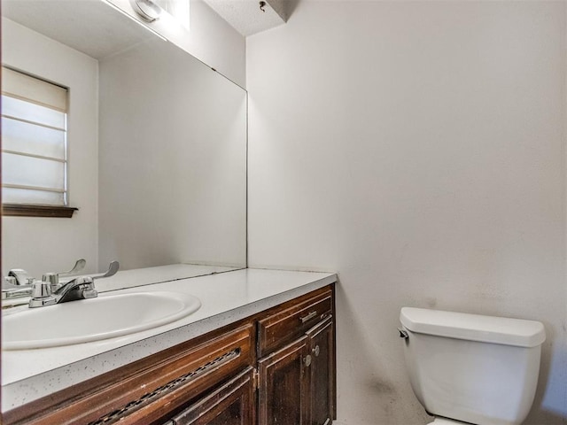 bathroom with toilet and vanity