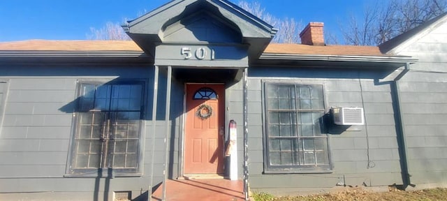 property entrance featuring a chimney