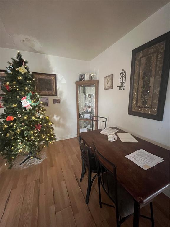 dining space with wood finished floors and baseboards