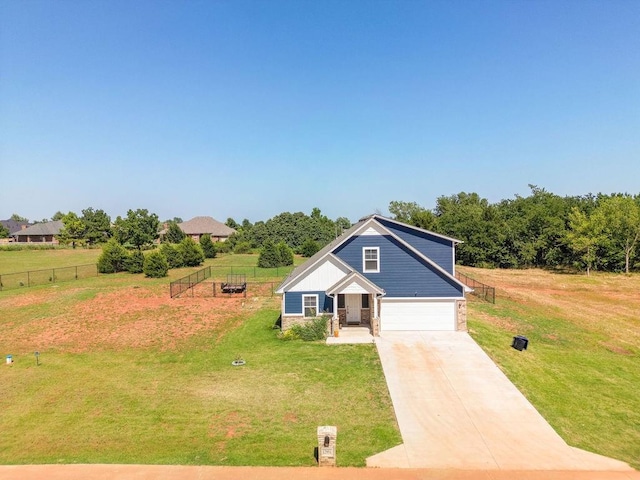 view of front facade featuring a garage, concrete driveway, a front yard, and fence