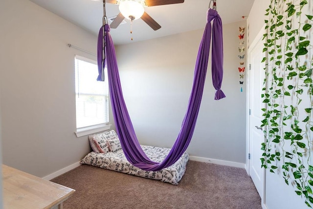 unfurnished bedroom featuring carpet flooring, baseboards, and ceiling fan