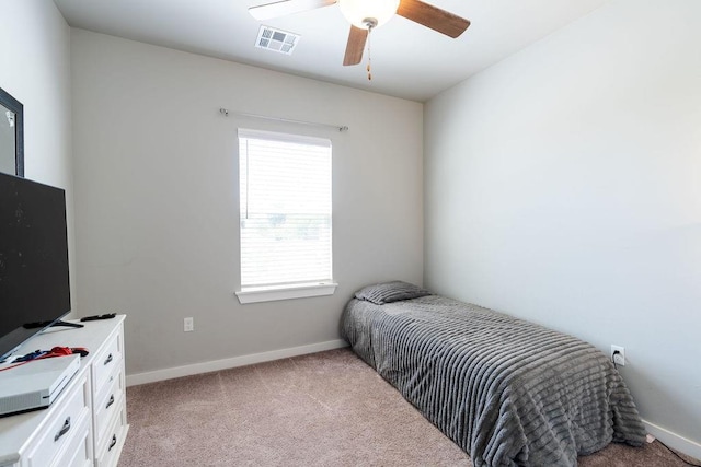 bedroom with a ceiling fan, light colored carpet, visible vents, and baseboards