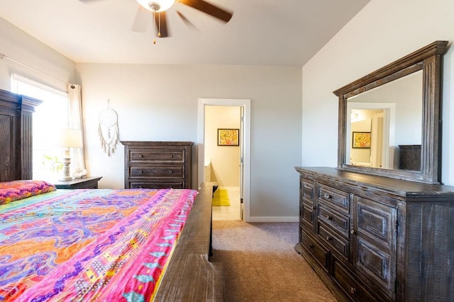 bedroom with carpet flooring, a ceiling fan, ensuite bathroom, and baseboards