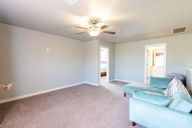 living area featuring visible vents, carpet flooring, a ceiling fan, and baseboards