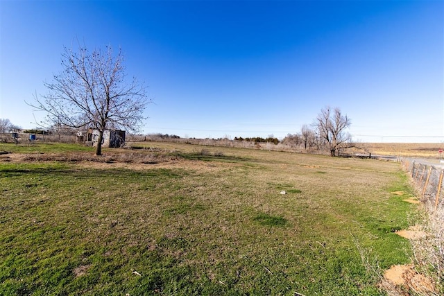 view of yard featuring a rural view and fence