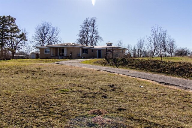 exterior space featuring driveway and a front lawn