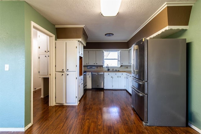 kitchen with crown molding, white cabinets, dark wood-style flooring, and appliances with stainless steel finishes