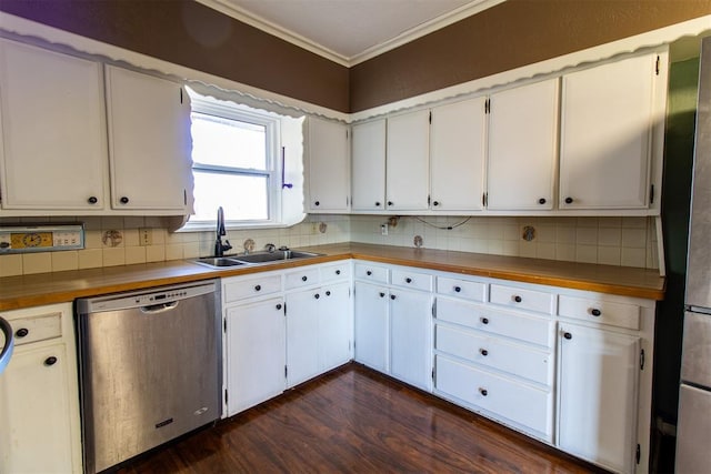 kitchen with a sink, backsplash, white cabinetry, appliances with stainless steel finishes, and crown molding