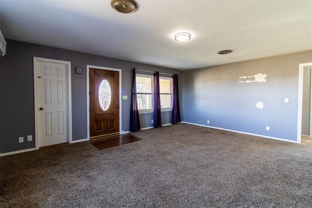 carpeted foyer entrance with baseboards