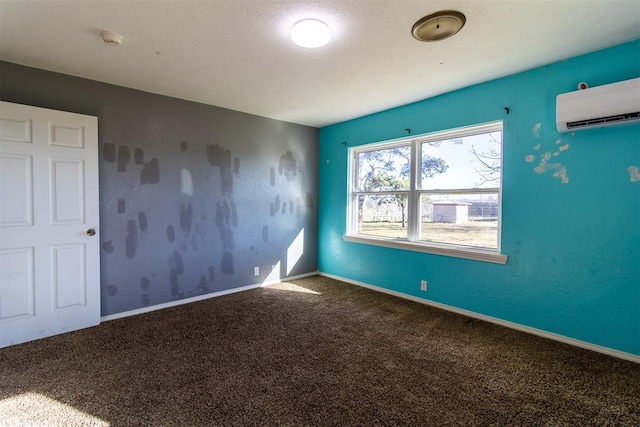 unfurnished room with a wall unit AC, carpet flooring, and baseboards