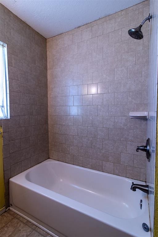 full bathroom featuring tile patterned flooring, a textured ceiling, and bathtub / shower combination