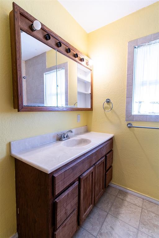 bathroom with vanity and baseboards