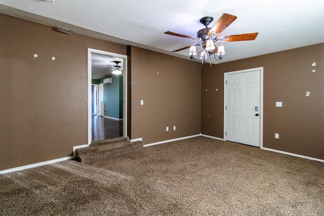 spare room featuring carpet flooring, ceiling fan, and baseboards