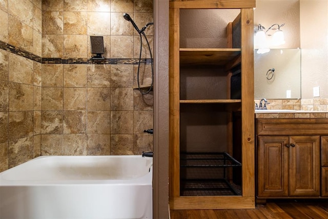 full bath with shower / bathing tub combination, wood finished floors, and vanity