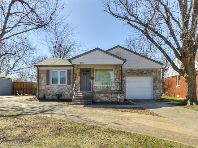 view of front of home featuring fence, a porch, concrete driveway, a garage, and stone siding