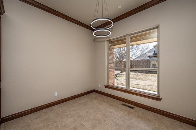 spare room with visible vents, baseboards, and crown molding