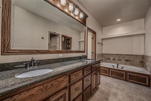 bathroom featuring a bath, tile patterned floors, double vanity, and a sink