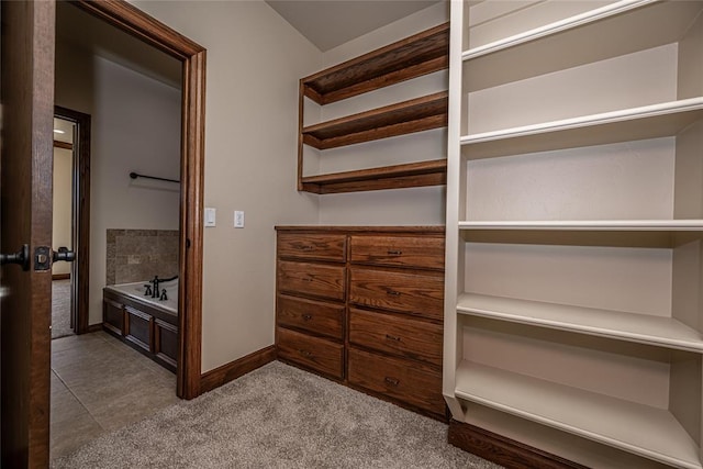 spacious closet featuring tile patterned floors and carpet floors