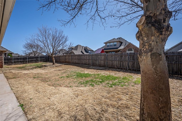 view of yard with a fenced backyard