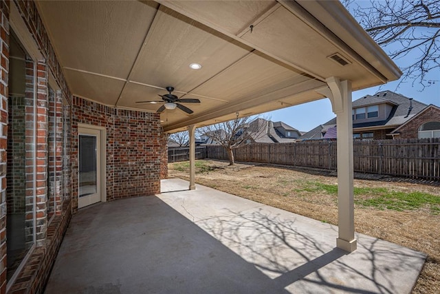 view of patio with a fenced backyard and a ceiling fan