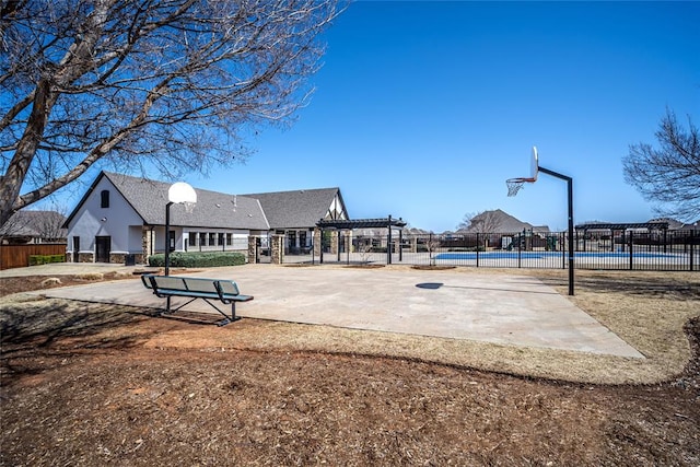 view of community featuring fence, community basketball court, and a pergola