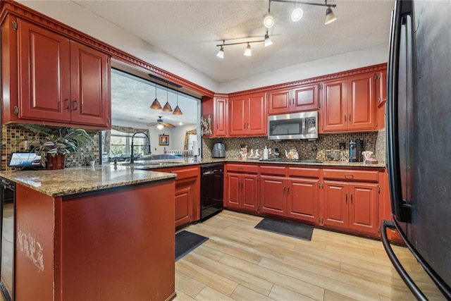 kitchen with backsplash, light wood-style flooring, black appliances, and a sink