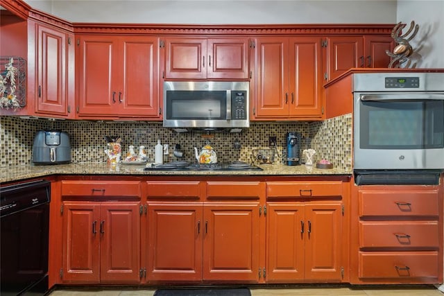 kitchen with backsplash, black appliances, and light stone countertops