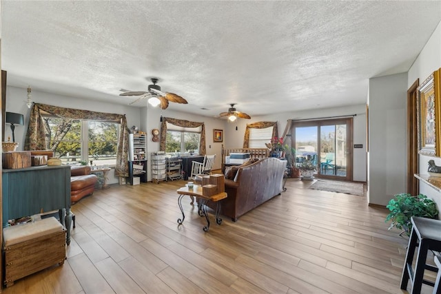 living room with a textured ceiling and wood finished floors