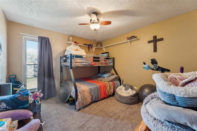 carpeted bedroom with a textured ceiling and ceiling fan