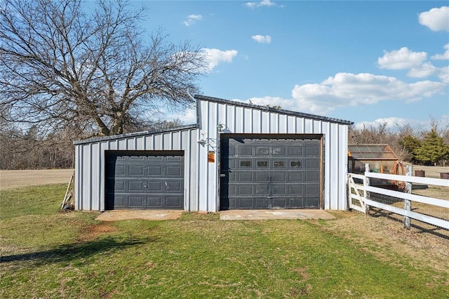 detached garage featuring fence