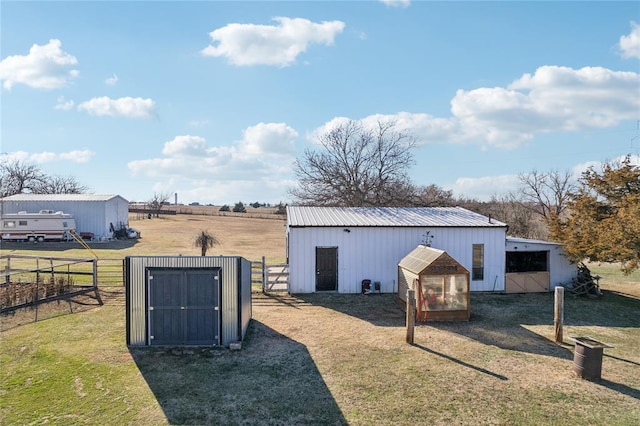 view of pole building with a lawn and fence