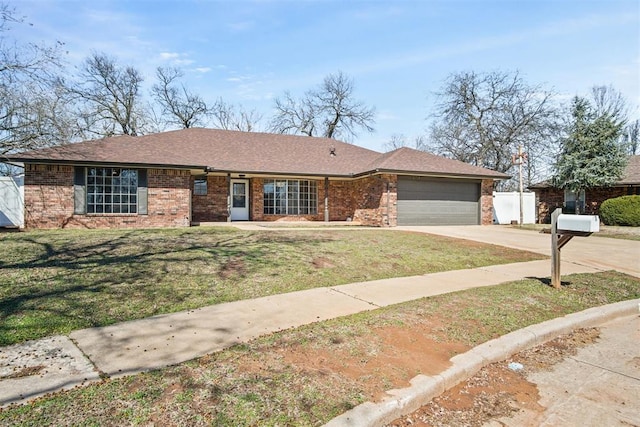 ranch-style house featuring a front lawn, roof with shingles, concrete driveway, a garage, and brick siding