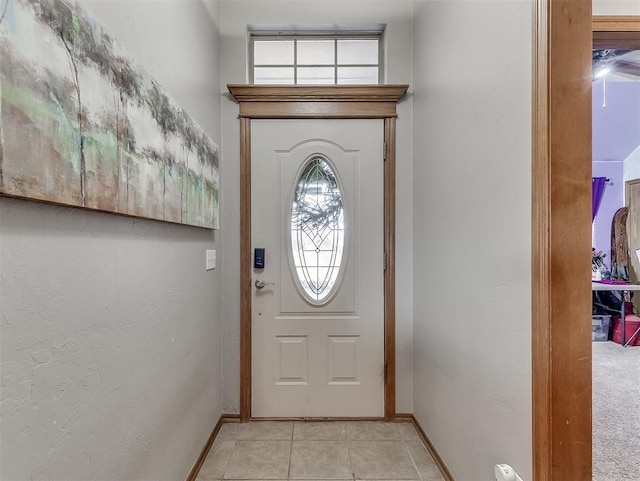 entryway featuring light tile patterned floors and baseboards