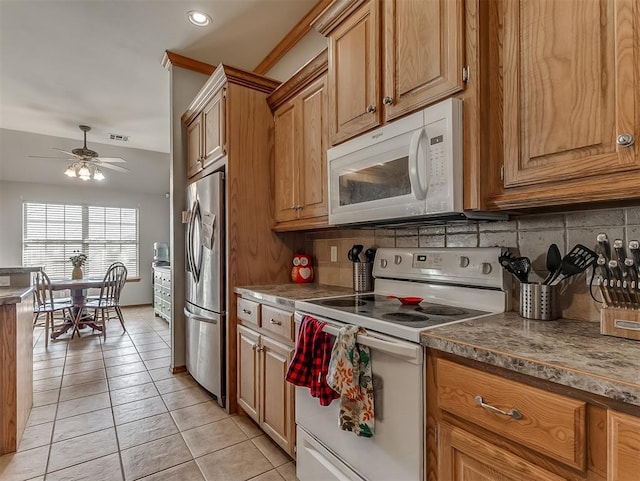 kitchen with light tile patterned floors, decorative backsplash, white appliances, and a ceiling fan