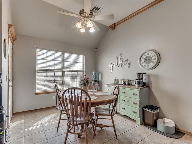 dining space featuring visible vents, baseboards, lofted ceiling, light tile patterned flooring, and a ceiling fan