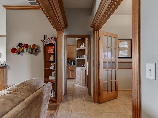 corridor featuring visible vents and light tile patterned flooring