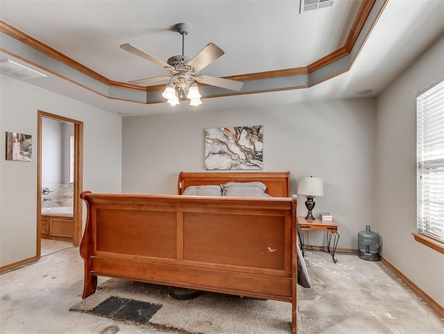 bedroom with visible vents, connected bathroom, baseboards, a tray ceiling, and ornamental molding