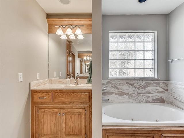 bathroom with a jetted tub and vanity