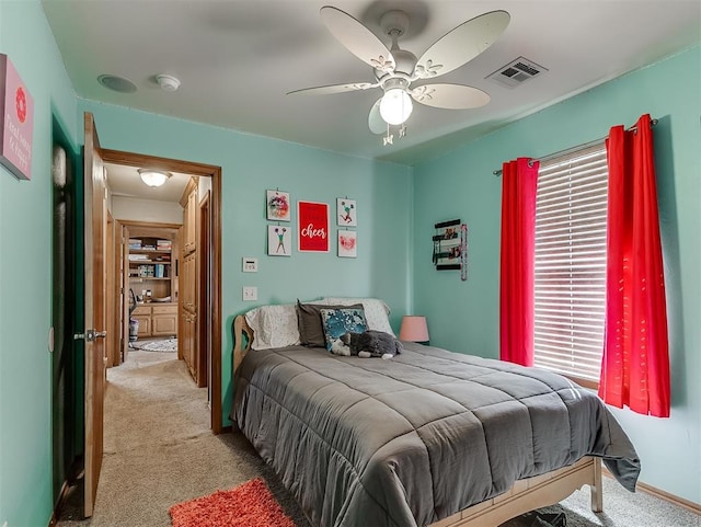 bedroom featuring visible vents, multiple windows, and light colored carpet