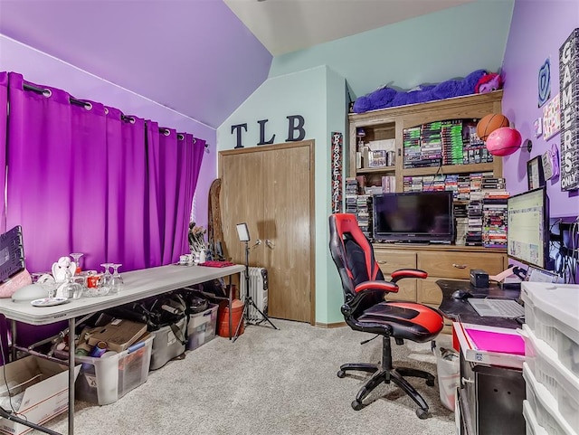 carpeted office with lofted ceiling