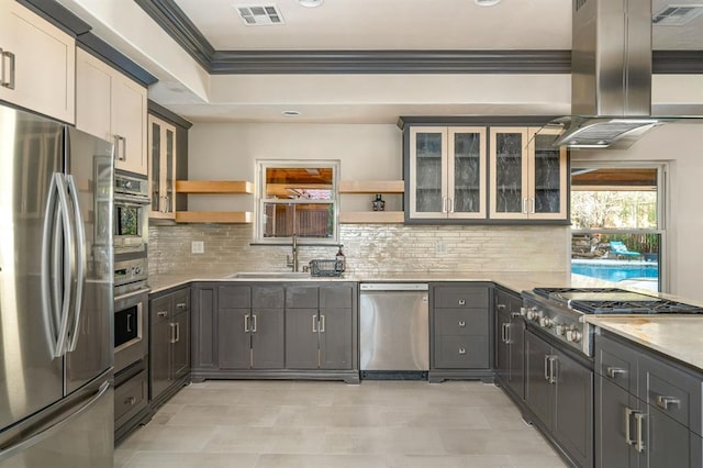 kitchen featuring open shelves, a sink, stainless steel appliances, crown molding, and island range hood