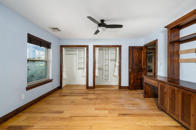 foyer featuring visible vents, baseboards, light wood-style flooring, and a ceiling fan