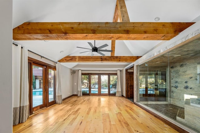 unfurnished room featuring a ceiling fan, lofted ceiling with beams, wood finished floors, french doors, and baseboards