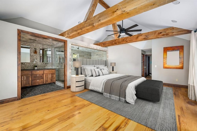 bedroom with lofted ceiling with beams, dark wood finished floors, connected bathroom, baseboards, and a spacious closet