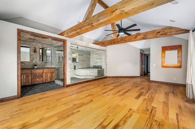 interior space with lofted ceiling with beams, baseboards, wood finished floors, and ceiling fan