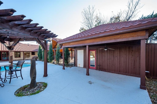 view of patio featuring an outdoor pool, a ceiling fan, and a pergola