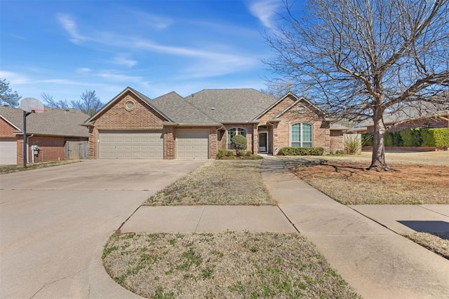 view of front of property with brick siding, driveway, a garage, and roof with shingles